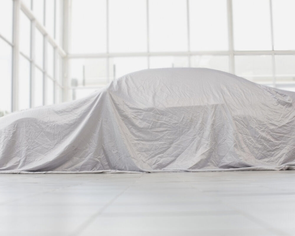 Car covered in cloth in garage